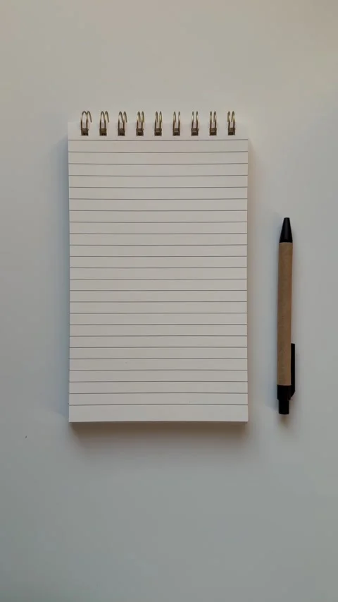 Empty note pad for making lists, notes and journaling with a pen on white tab Stock Footage 328303567