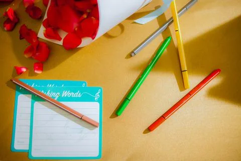 Empty note pad for writing and colorful pens with rose Stock Photos