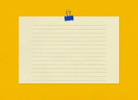 Empty note paper with clip on yellow art paper background. Stock-Fotos