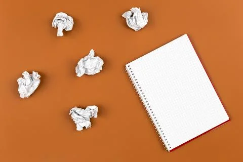 Empty notebook and crumpled paper balls, flat lay. Stock Photos