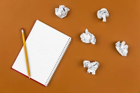 Empty notebook and crumpled paper balls, flat lay. Stock Photos
