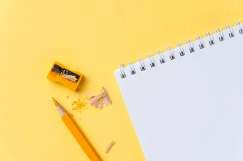 Empty notebook and pencil on bright yellow background Stock Photos