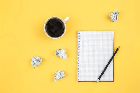 Empty notebook with cup of coffee and crumpled paper balls, flat lay. Stock Photos
