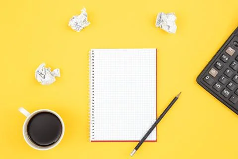 Empty notebook with cup of coffee and crumpled paper balls, flat lay. Stock Photos