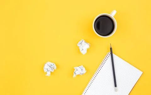 Empty notebook with cup of coffee and crumpled paper balls, flat lay. Stock Photos