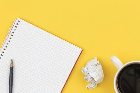 Empty notebook with cup of coffee and crumpled paper balls, flat lay. Stock Photos