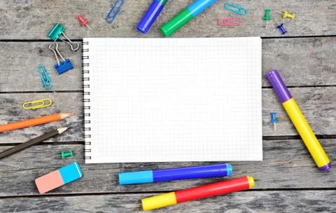 Empty notebook with many school objects on desk Stock Photos