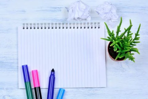 Empty notebook with marker and flower on table Stock Photos