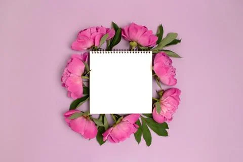 Empty notebook mockup with wreath made of peony flowers. Stock Photos