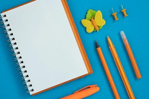 Empty notebook page for your text with orange school and office stationery Stock Photos