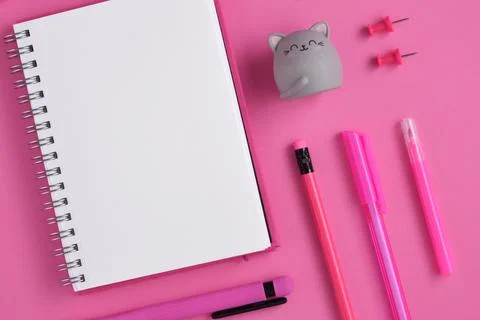 Empty notebook page for your text with pink stationery on magenta background Stock Photos