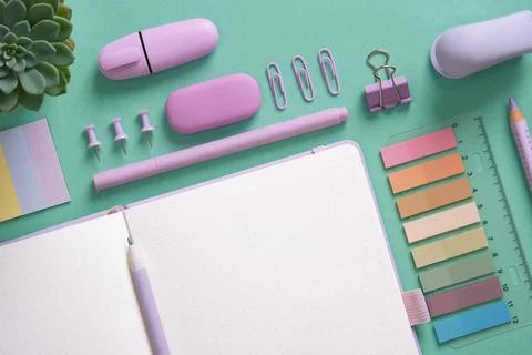 Empty notebook page for your text with violet school and office stationery on Stock Photos