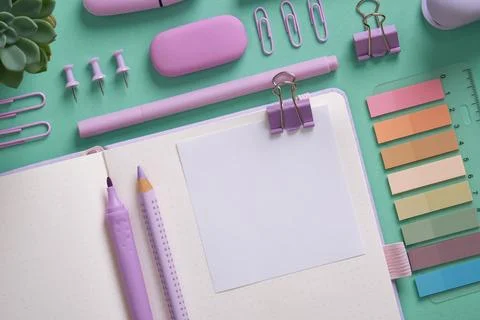 Empty notebook page for your text with violet school and office stationery on Stock Photos