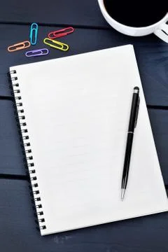 Empty notebook with pen and coffee cup on desk Stock Photos
