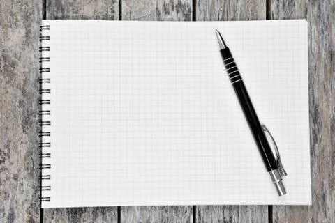 Empty notebook with pen on a wood table Stock Photos