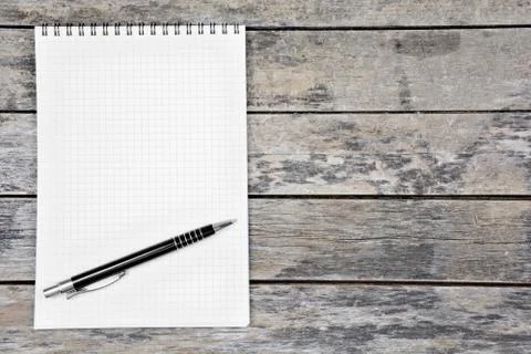 Empty notebook with pen on a wood table Stock Photos