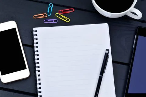Empty notebook with phone and digital tablet on desk Foto stock