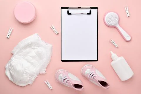 An empty notebook on a pink background with children's accessories for body c Stock Photos