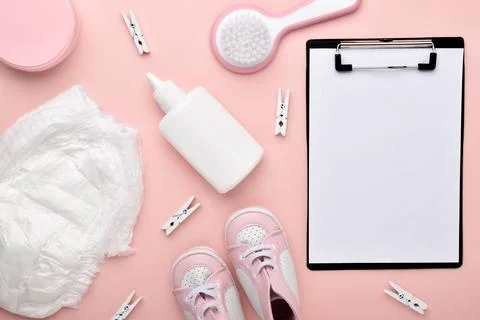 An empty notebook on a pink background with children's accessories for body c Stock Photos