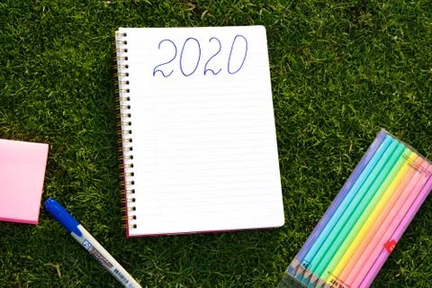 Empty notebook ready for New 2020 Year planing or wish list in the grass with Stock Photos