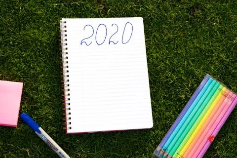 Empty notebook ready for New 2020 Year planing or wish list in the grass with Stock Photos