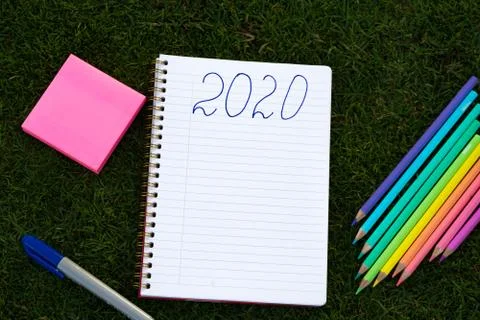 Empty notebook ready for New 2020 Year planing or wish list in the grass with Stock Photos