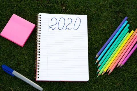 Empty notebook ready for New 2020 Year planing or wish list in the grass with Stock Photos