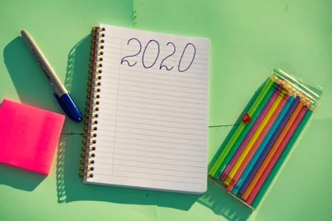 Empty notebook ready for New 2020 Year planing or wish list in the grass with Stock Photos