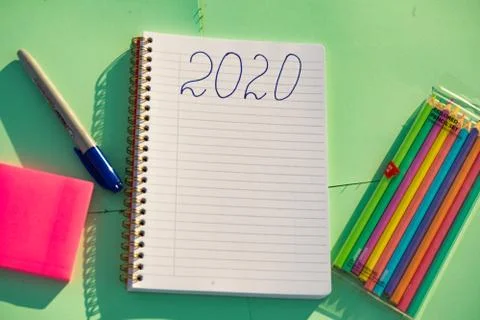 Empty notebook ready for New 2020 Year planing or wish list in the grass with Stock Photos