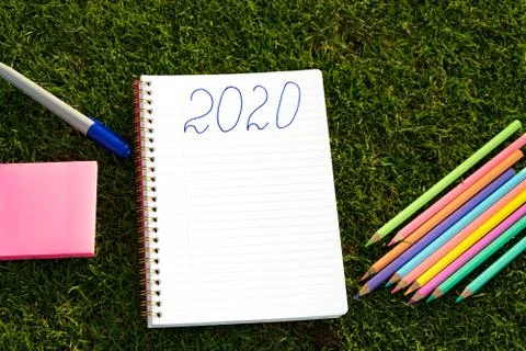 Empty notebook ready for New 2020 Year planing or wish list in the grass with Stock Photos