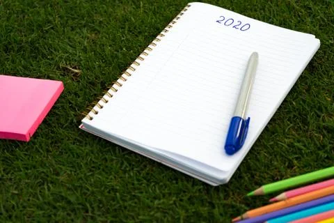 Empty notebook ready for New 2020 Year planing or wish list in the grass with Foto stock
