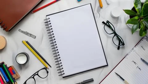Empty notebook is spread on desk mockup, stationery. back to school concept Stock Photos