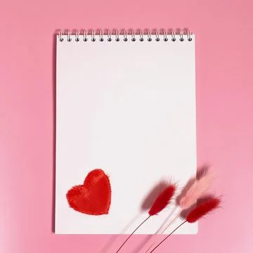 Empty notebook with a spring, a red textile heart and dried lagurus flowers Stock Photos