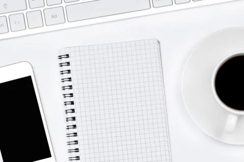 Empty notepad with coffee, keyboard computer and telephone on white backgroun Stock Photos