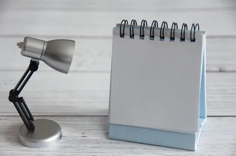 Empty notepad with customizable space for text and ideas. With table lamp o.. Stock Photos