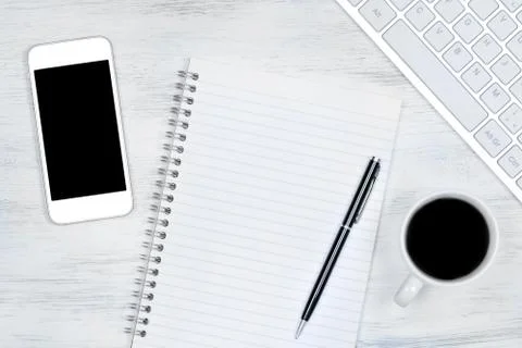 Empty notepad with keyboard, phone and coffee cup Stock Photos