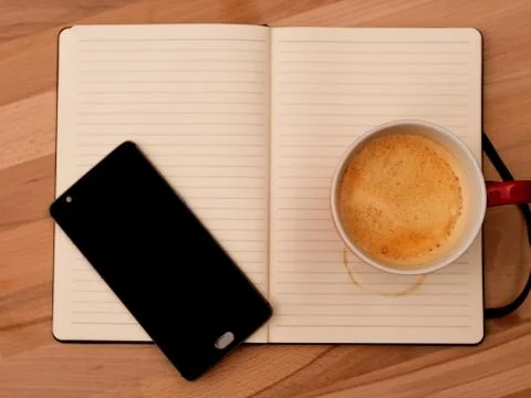Empty notepad, with a mobile phone and Cafe. Stock Photos