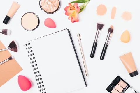 Empty notepad with pen among cosmetics Stock Photos