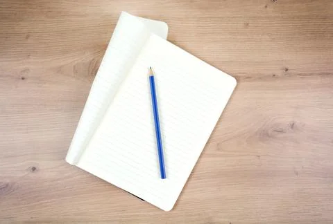 Empty notepad with pencil on wooden table Stock Photos