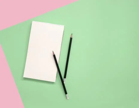Empty notepad with pencils on color background. Stock Photos