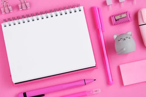 Empty notepad sheet with pink on magenta background. Eraser in form of cat. Stock Photos