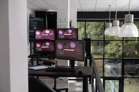 Empty office with computer monitors showing hacking warning alert Stock-Fotos