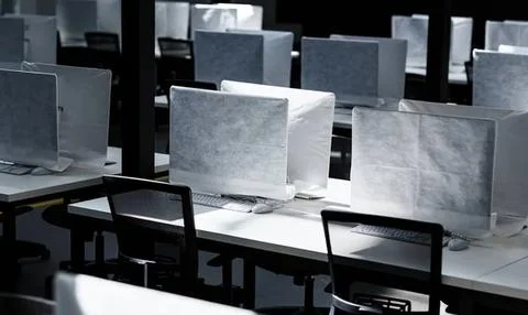 Empty office with computers and chairs in a modern workspace Foto stock