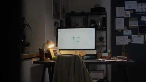 Empty Office Desk with Glowing Computer Screen Showing Overtime Stock Footage 338415405