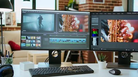 Empty office desk with a video editing software running on computer Stock Photos