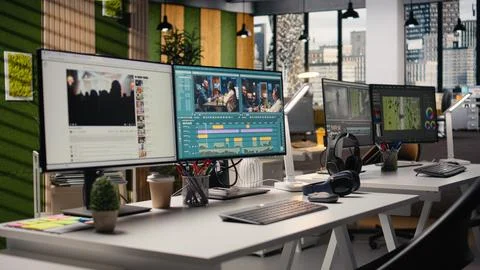 Empty office with footage editing program and streaming platform dual monitors Stock Photos