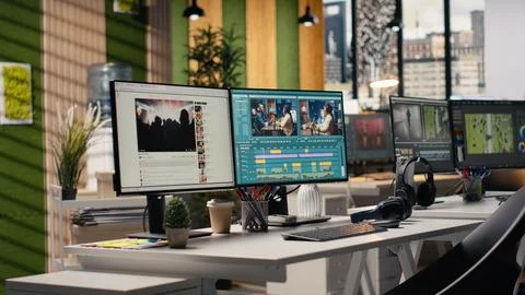 Empty office with footage editing program and streaming platform dual monitors Stock Photos