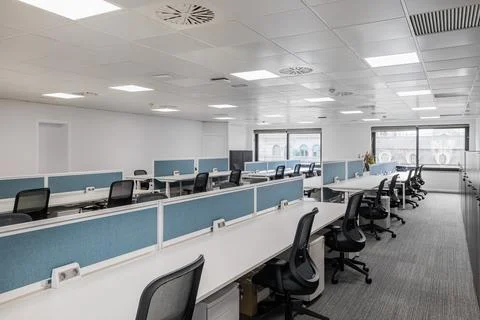 Empty office in gray tones with long tables and chairs for employees of managers 库存照片