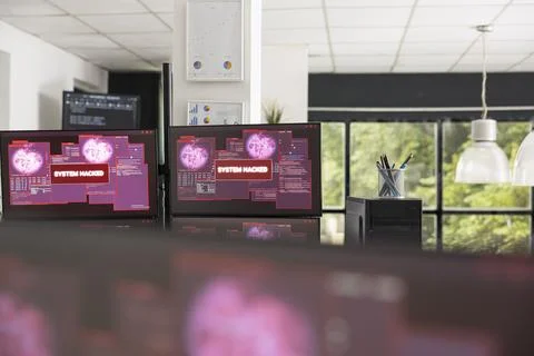 Empty office with hacked system alert on monitors 库存照片