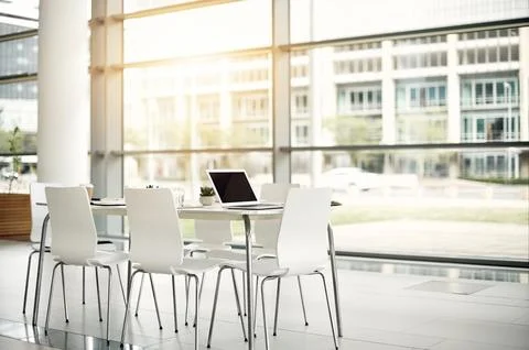 Empty office, laptop on table and meeting room in company for seminar Stock Photos